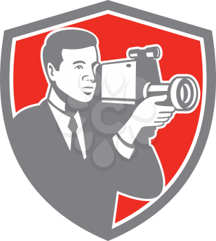 Illustration of a video cameraman carrying vintage video camera shooting set inside shield crest on isolated background done in retro style. 