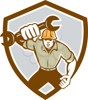 Illustration of a mechanic running holding spanner wrench pumping fist set inside shield crest on isolated background done in retro style.