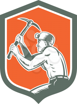 Illustration of a coal miner hardhat with crossed pick axe working viewed from the side set inside shield crest on isolated background done in retro style.