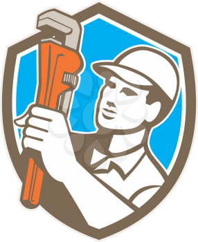 Illustration of a plumber holding monkey wrench looking to the side set inside shield crest on isolated background done in retro style. 