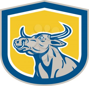 Illustration of an bull head facing to side set inside crest shield on isolated background done in retro style.