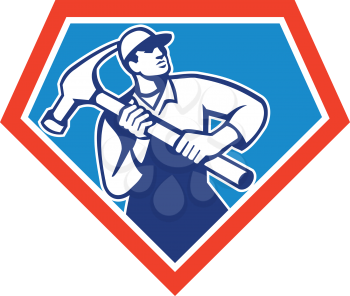 Illustration of a carpenter builder handyman carrying a giant hammer set inside shield crest shape on isolated background done in retro style.

