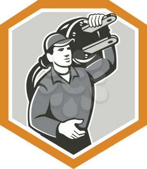 Illustration of a electrician worker with electric plug carrying on shoulder facing front set inside shield crest on isolated background done in retro style.