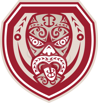 Illustration of a traditional maori mask with tongue out facing front set inside shield done in retro style on isolated background.