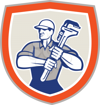 Illustration of a plumber holding a giant monkey wrench set inside shield facing front done in retro woodcut style on isolated background.