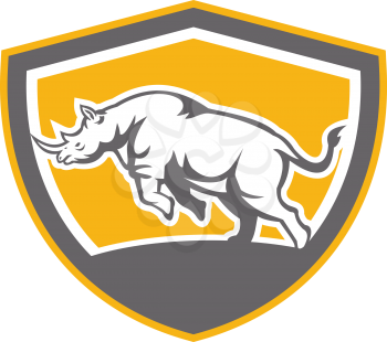 Illustration of a rhinoceros charging side view set inside shield crest shape on isolated background done in retro style.