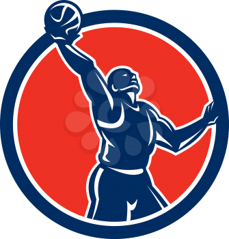 Illustration of a basketball player rebounding lay-up ball viewed from the side set inside circle on isolated background done in retro style.