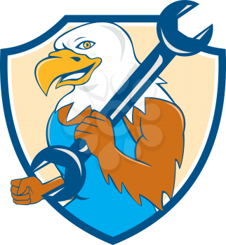 Illustration of a american bald eagle mechanic smiling holding wrench on shoulder viewed from side set inside shield crest done in cartoon style. 