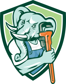 Illustration of an african elephant plumber mascot holding monkey wrench set inside shield crest on isolated background done in retro style. 