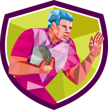 Low polygon style illustration of rugby union player with ball fending running set inside shield crest on isolated background. 