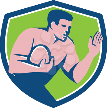 Illustration of a rugby player holding ball fending fend off with hand out set viewed from the side inside shield crest on isolated background done in retro style.