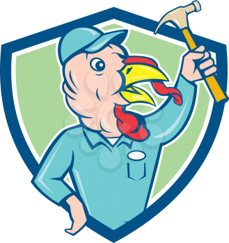 Illustration of a wild turkey builder holding clutching hammer looking to the side set inside shield crest done in cartoon style on isolated background.