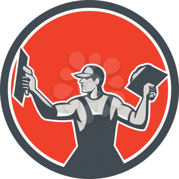 Illustration of a plasterer masonry tradesman construction worker with trowel extending arms looking to the side viewed from front set inside circle done in retro style on isolated background.
