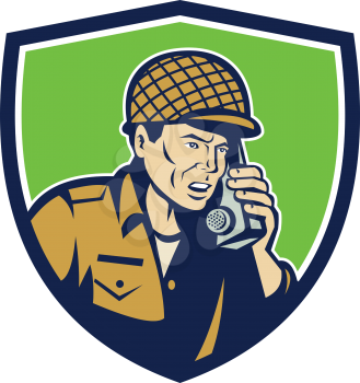 Illustration of a World War two American soldier serviceman talking on field radio walkie-talkie viewed from front set inside shield crest on isolated background done in retro style. 