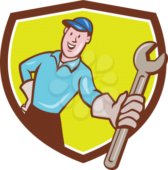 Illustration of a mechanic wearing hat and gloves holding presenting wrench spanner facing front set inside shield crest on isolated background done in cartoon style. 