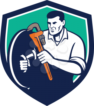 Illustration of a plumber holding brandishing monkey wrench set inside shield crest on isolated background done in retro style. 