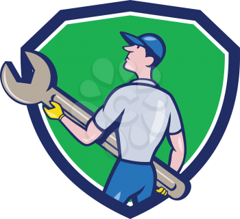 Illustration of a mechanic carrying giant spanner looking up to the side viewed from rear set inside shield crest on isolated background done in cartoon style. 