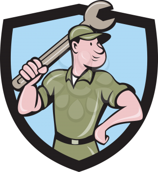 Illustration of a mechanic wielding holding spanner wrench looking to the side with one hand on hips viewed from front set inside shield crest on isolated background done in cartoon style. 