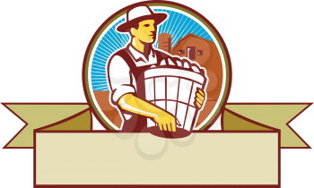 Illustration of an organic farmer carrying basket of harvest crops looking to the side set inside circle and ribbon with barn and sunburst in the background done in retro style. 