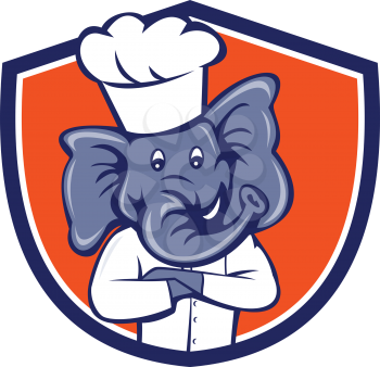 Illustration of a chef elephant wearing chef's hat with arms crossed viewed from front set inside shield crest on isolated background done in cartoon style.
