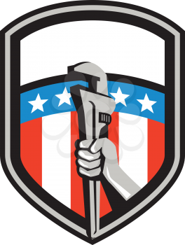 Illustration of a plumber hand holding adjustable pipe wrench viewed from the side set inside shield crest with usa american stars and stripes flag in the background done in retro style. 