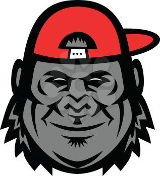 Mascot icon illustration of head of a gorilla wearing a baseball cap or hat from side viewed from front  on isolated background in retro style.