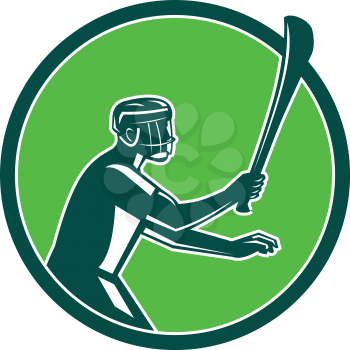 Retro style illustration of a hurling player holding a wooden stick called hurley viewed from side on isolated background.