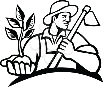 Black and white illustration of an organic farmer wearing a hat holding a plant by the palm of his hand with grab hoe on his shoulder looking to side on isolated background in retro style.