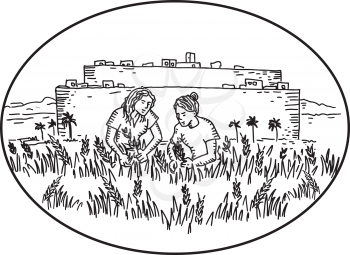 Retro style illustration of two women gathering or harvesting wheat in farm outside a walled city set inside oval shape on isolated background done in black and white.