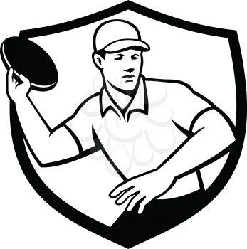 Mascot icon illustration of an disc golf player throwing a flatball or frisbee set inside crest or shield shape viewed from front on isolated background in Black and White retro style.
