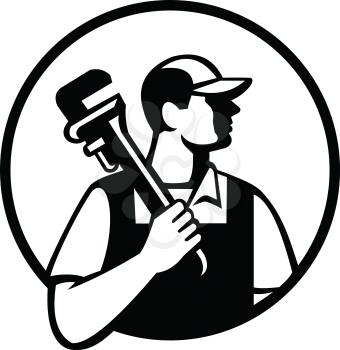 Black and white illustration of a plumber holding pipe wrench on shoulder looking to the side viewed from front set inside circle on isolated background done in retro style. 