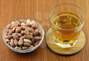 Royalty Free Photo of a Shot of Whiskey and Peanust on a Bar