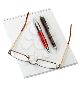 Royalty Free Photo of a Blank Notebook, Pens and Glasses