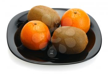 Kiwi and mandarin on a black plate on a white background