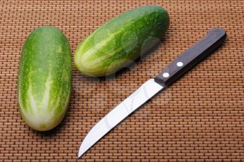 Royalty Free Photo of Two Cucumbers and a Knife