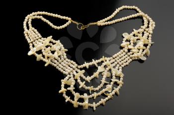 Royalty Free Photo of a Necklace of Artificial Pearls With Mother-of-Pearl Accents