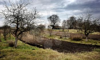 Royalty Free Photo of a Country Village and Plowed Field