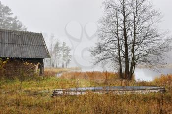 Royalty Free Photo of an Outbuilding and Country Field on a Misty Morning