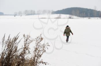 Royalty Free Photo of a Boy Walking on a Frozen Lake