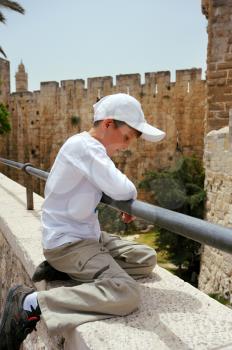 Royalty Free Photo of a Boy on a Wall in the Old City of Jerusalem