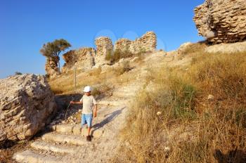 Royalty Free Photo of a Boy on the Remnants of Fortifications That Were Built by the Crusaders in Ashqelon, Israel