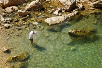 Royalty Free Photo of a Boy Wading in the Water at the Ein Gedi Nature Reserve