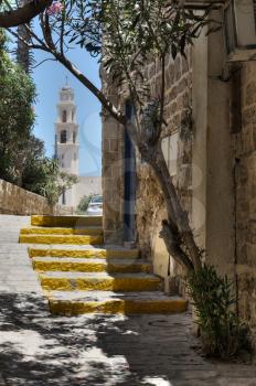 Royalty Free Photo of a Street in Old Jaffa With a Church Spire in the Background