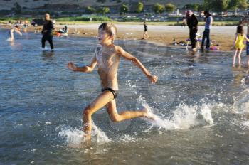 Royalty Free Photo of a Boy Running in Water