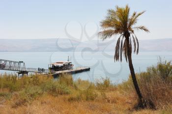 Royalty Free Photo of a Ship at a Pier on Lake Kinneret