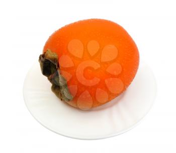 Persimmon on a white plate on a white background, isolated