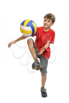Boy in red shirt playing with a soccer ball.