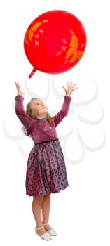 Girl in a smart dress plays with a red balloon.