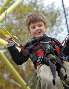 Royalty Free Photo of a Boy on Playground Equipment