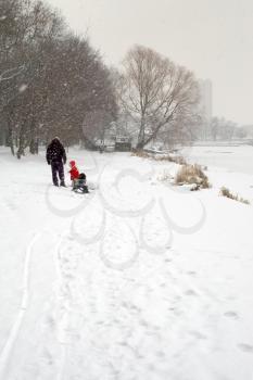 Royalty Free Photo of a Person and Child Walking in Winter